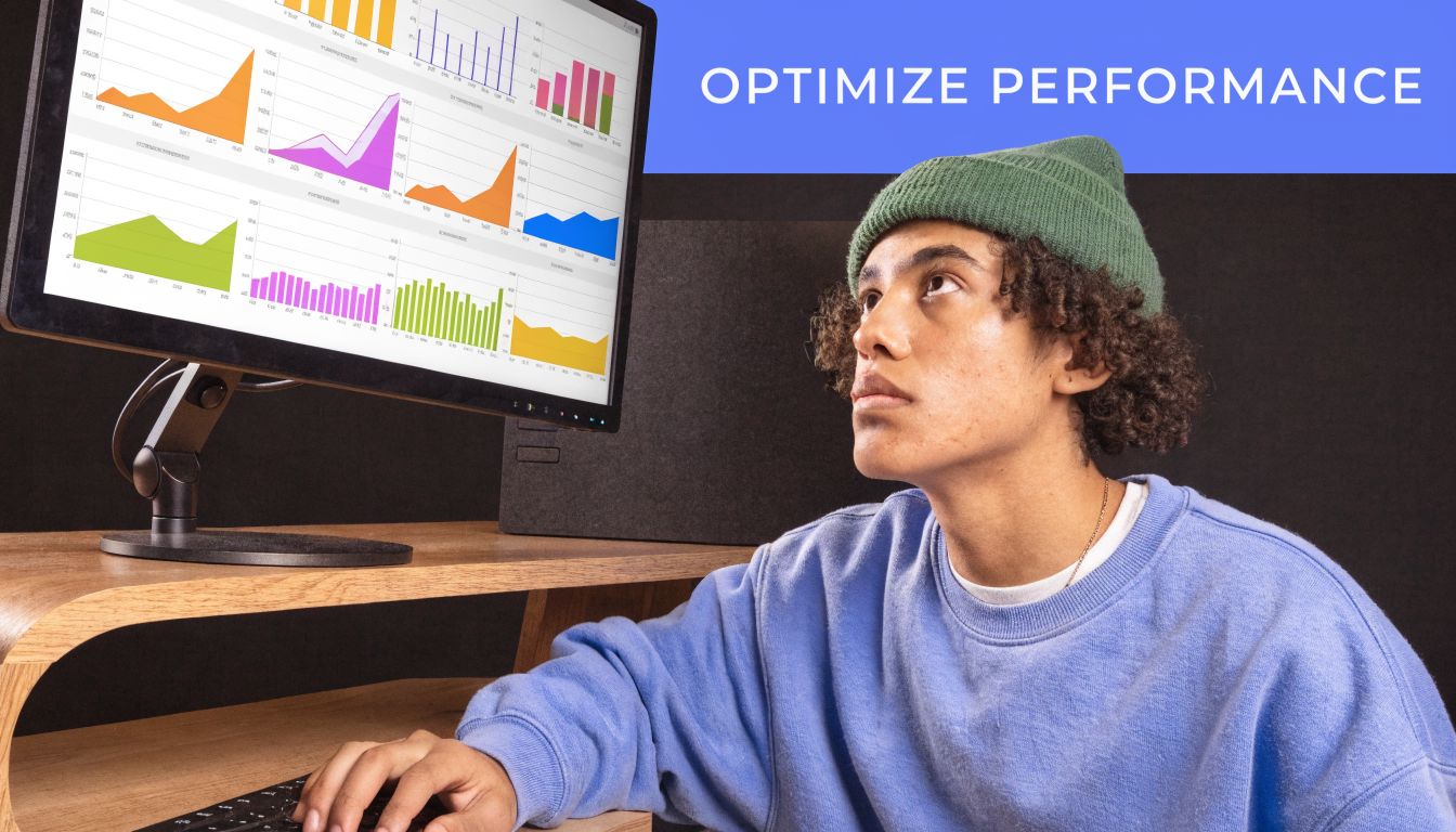 A young person wearing a green beanie looks intensely at a computer screen showing various data charts.