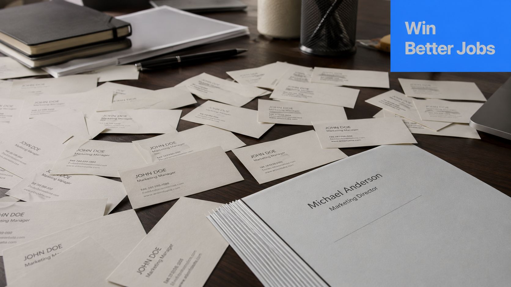 A professional desk workspace featuring a stack of business cards and a folder labeled Michael Anderson.